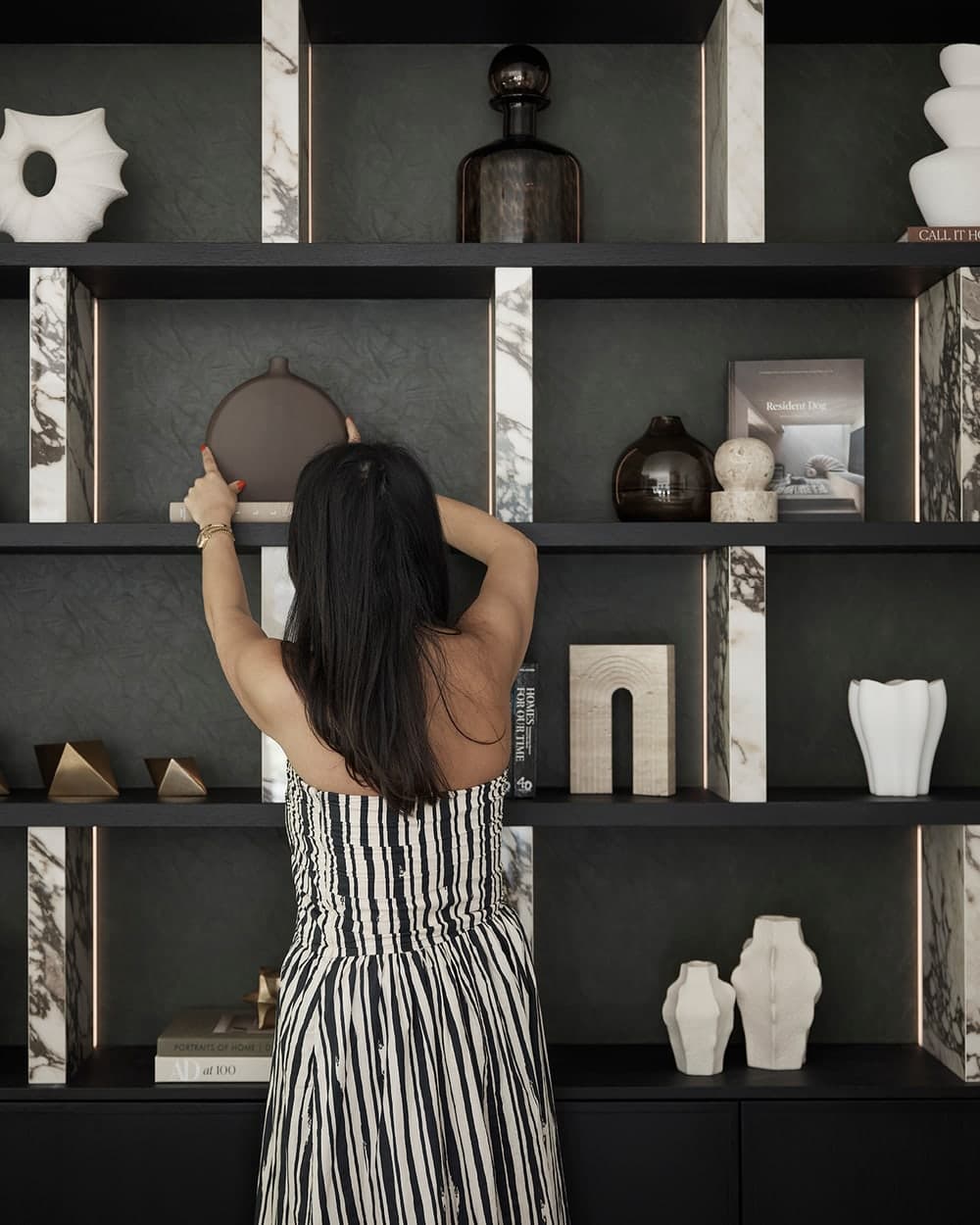 Steph Hakim styling a bespoke shelving display in the Prestbury family home