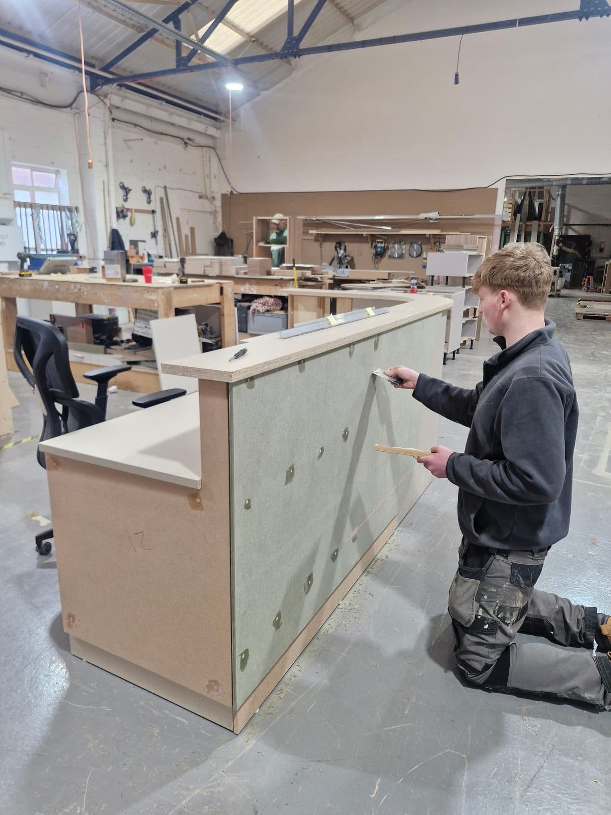 The curved reception desk under construction in the workshop