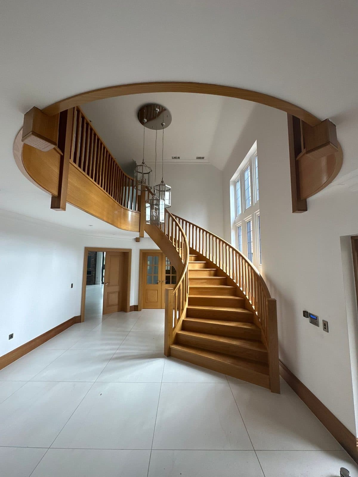 The bare entrance hall and staircase before the renovation