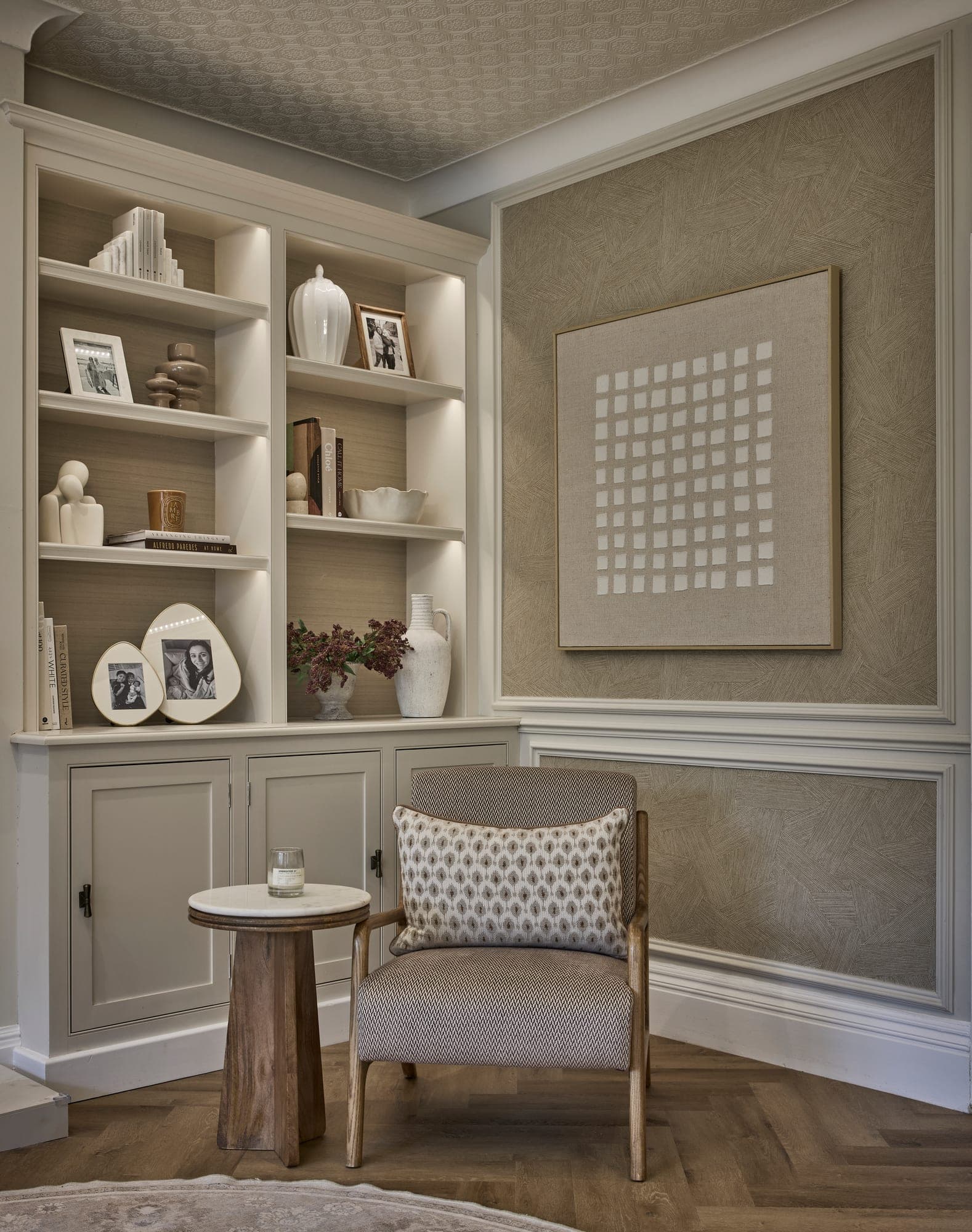 Lit alcove shelving and panelling in a Hale family home