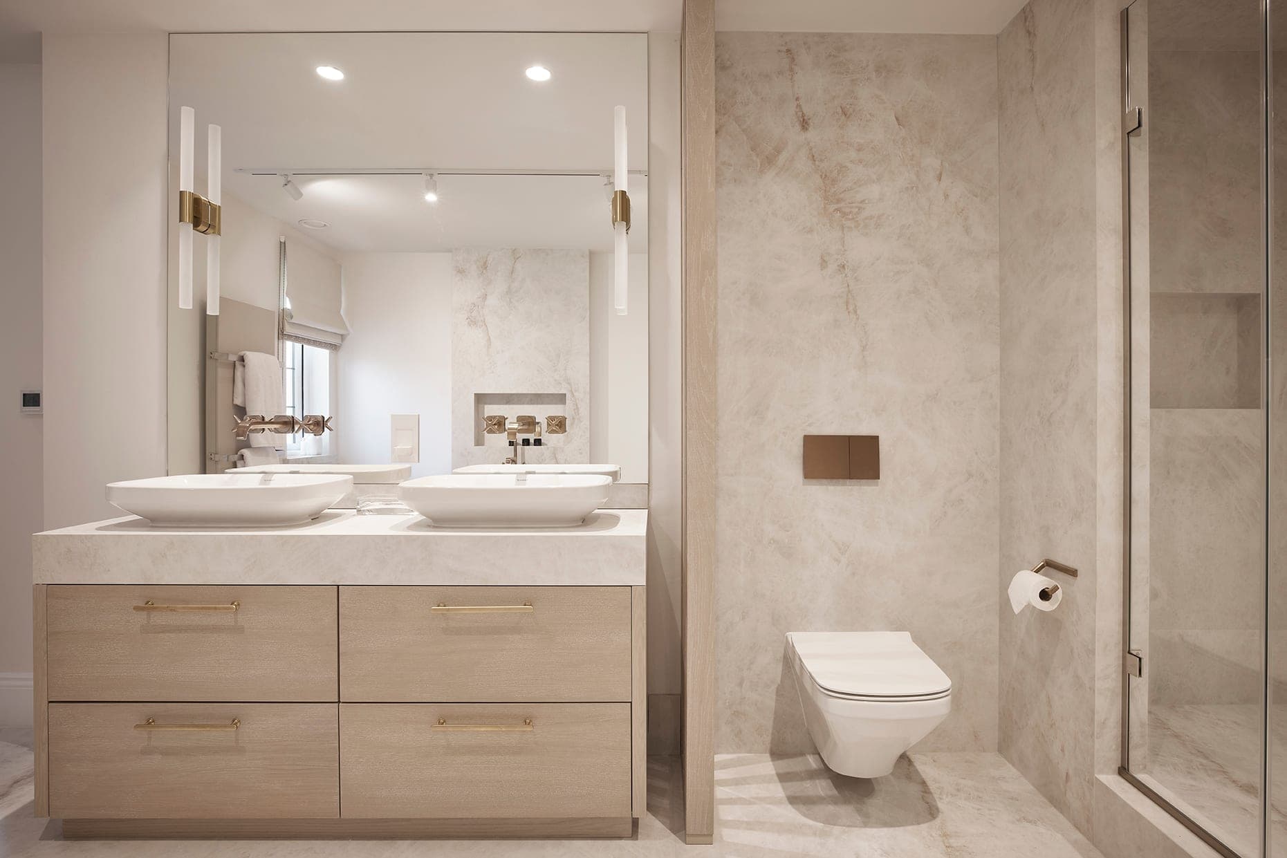 A luxury bathroom with a double vanity, twin basins and a marble walk-in shower in a Prestbury home, Cheshire
