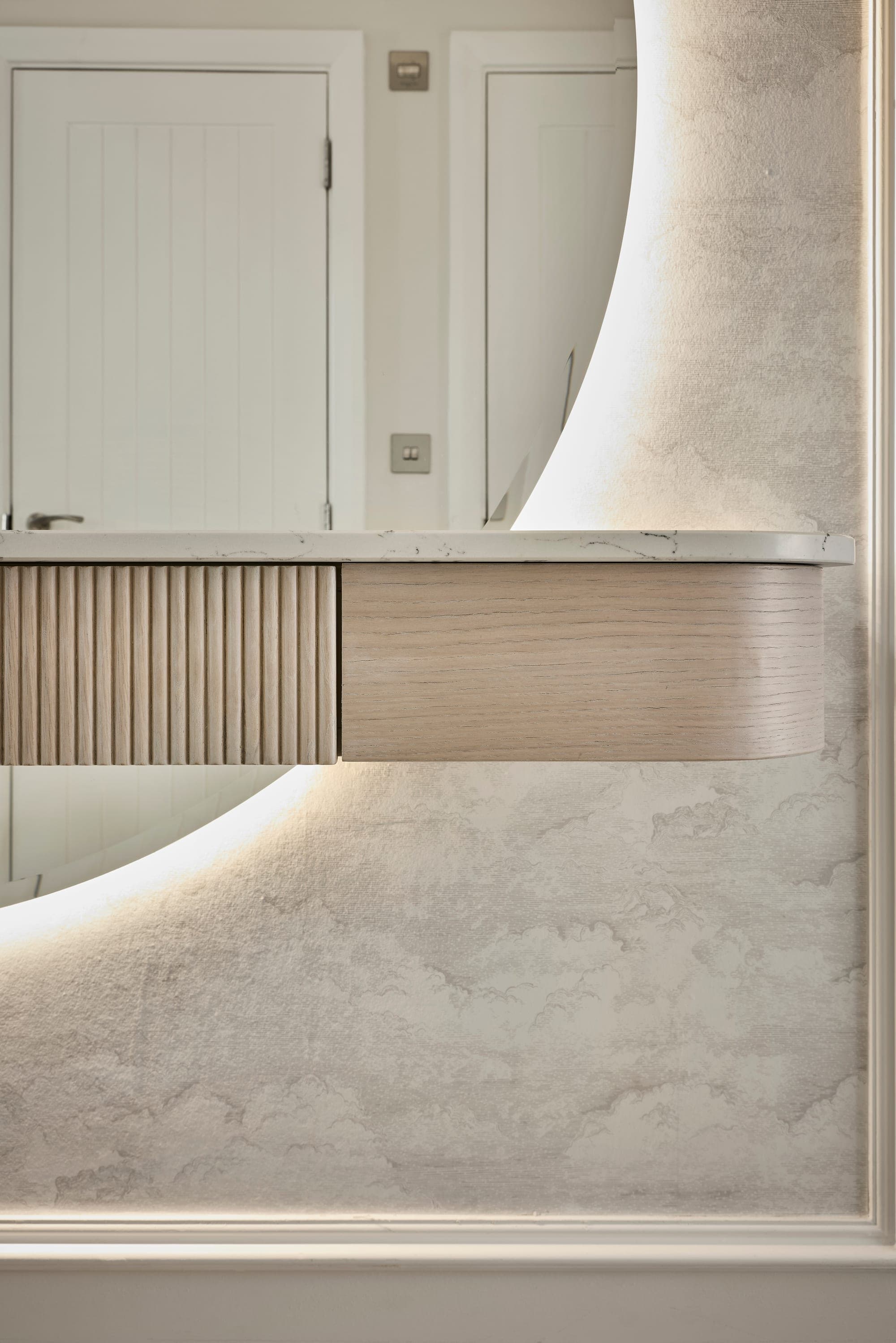 A detail of the curved oak console, reeded drawers and marble top