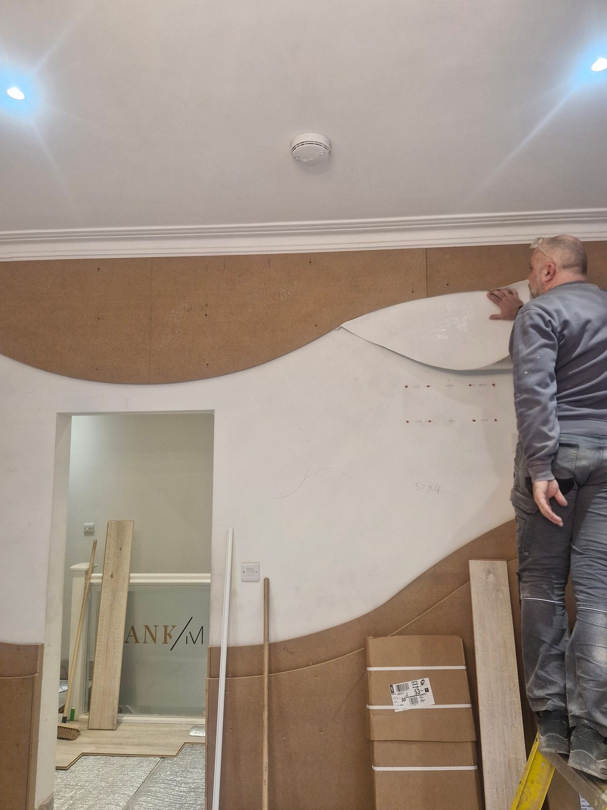 Templating the curved feature wall by hand on site