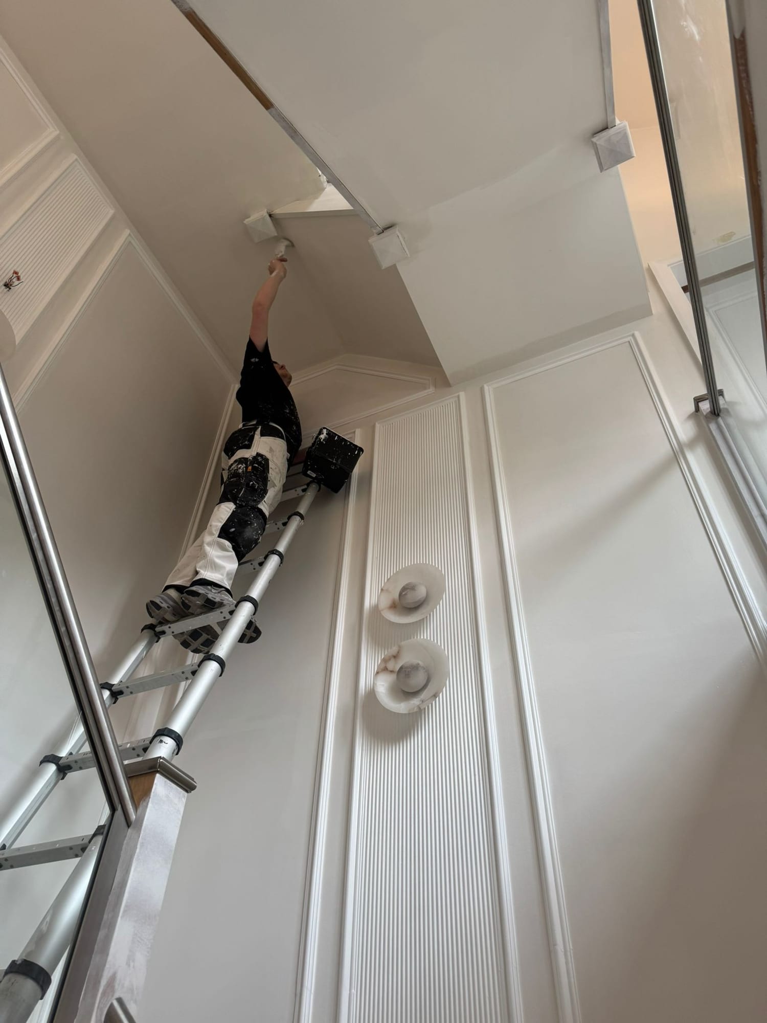 The new cornice and panelling being hand-painted on site