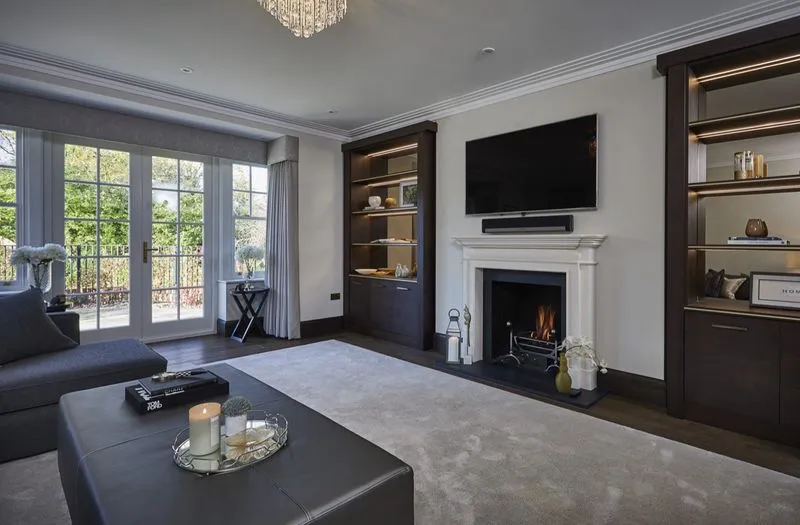 A fireplace surround and fitted joinery give a room character and a sense of permanence