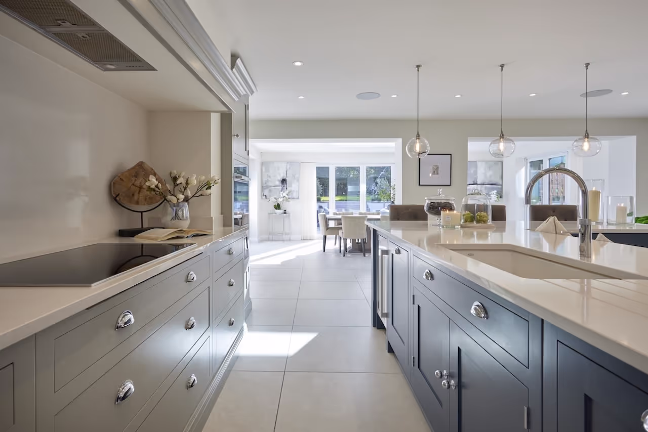 An open-plan kitchen with a marble island in a Hale Barns home