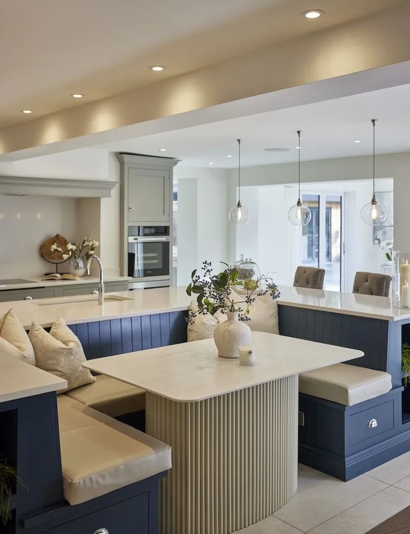 A kitchen island with a curved breakfast banquette in a Hale Barns home