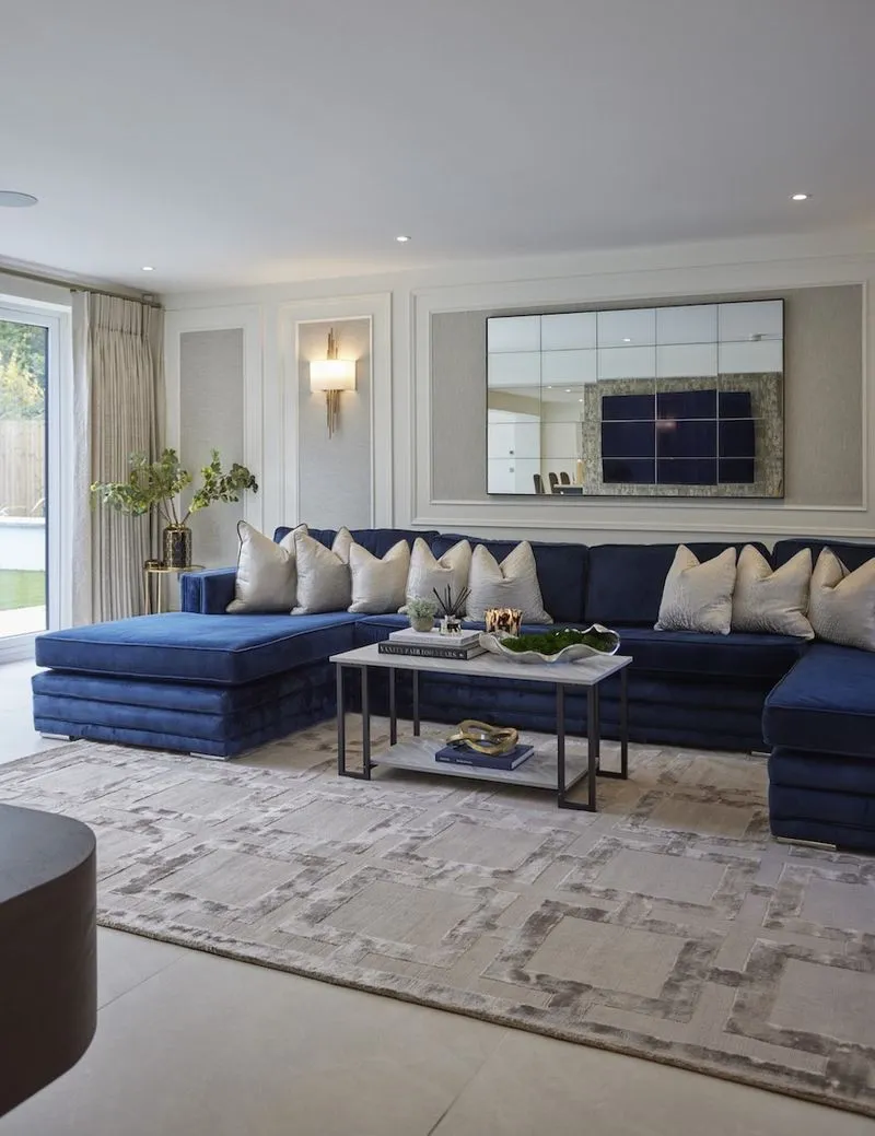 A deep navy sofa and styled coffee table in a Hale Barns living room