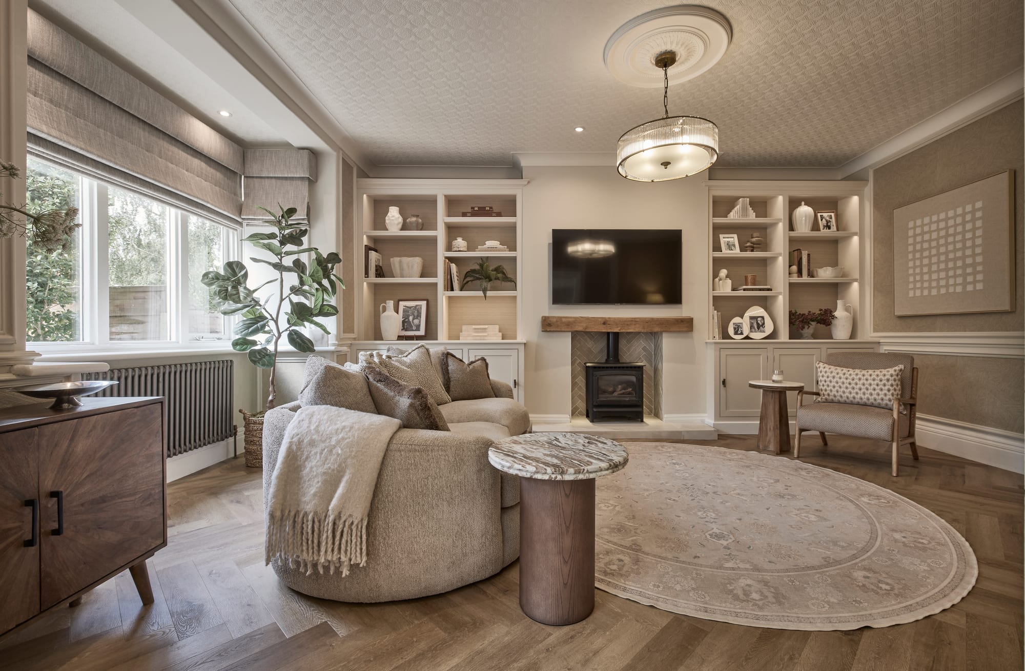 A family room with a wood burner and bespoke alcove shelving in a Hale home