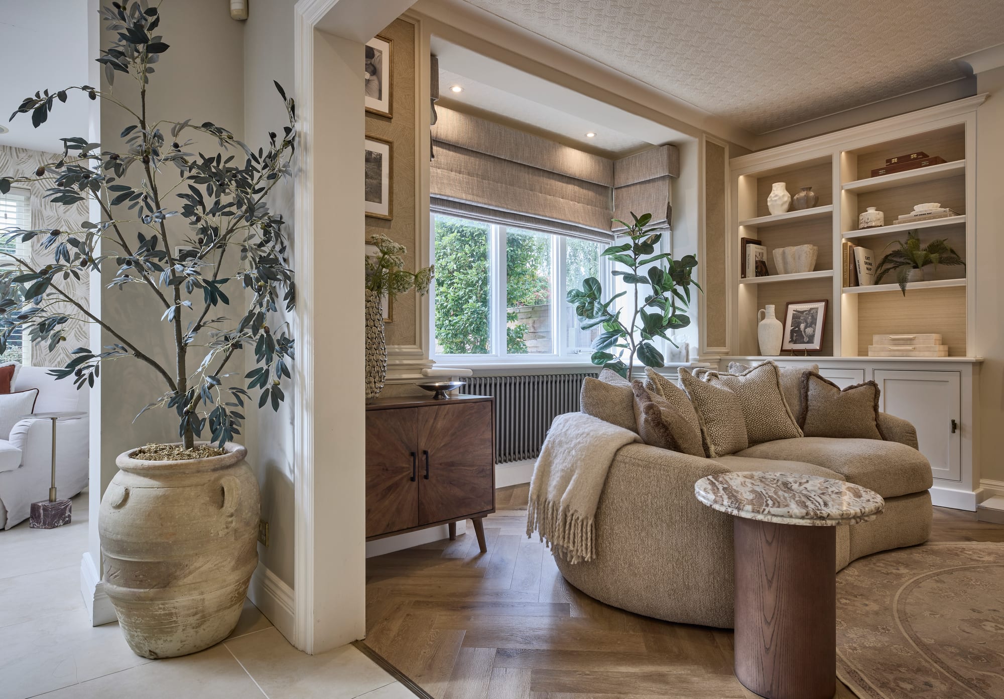 A layered living room with soft seating and natural light in a Hale home