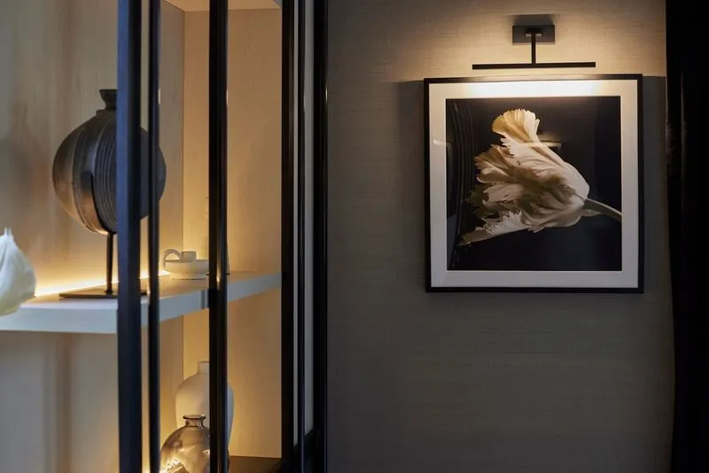 A backlit display cabinet framing a piece of art in a Knutsford home